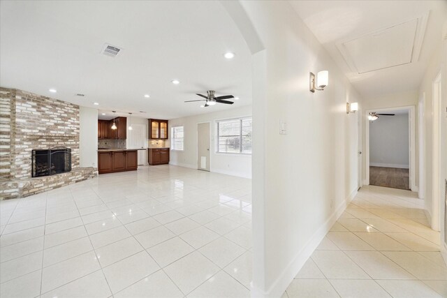 unfurnished living room featuring visible vents, a fireplace, ceiling fan, recessed lighting, and light tile patterned floors