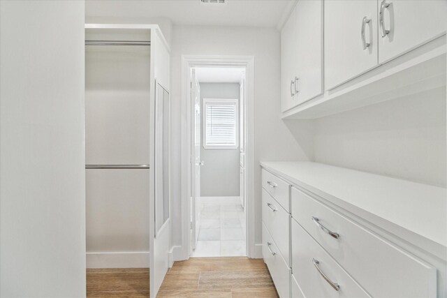 interior space featuring baseboards and visible vents