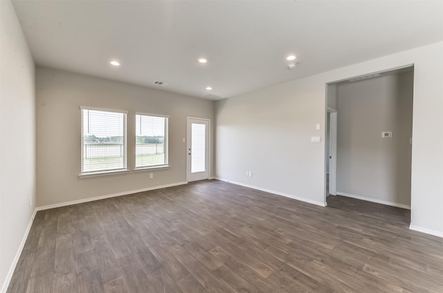 16524 Cascading Pines Ct, Conroe, TX 77302 - spare room featuring dark wood-style flooring, baseboards, visible vents, and recessed lighting