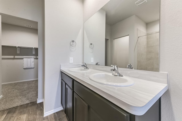 16524 Cascading Pines Ct, Conroe, TX 77302 - full bath featuring double vanity, visible vents, a sink, and wood finished floors