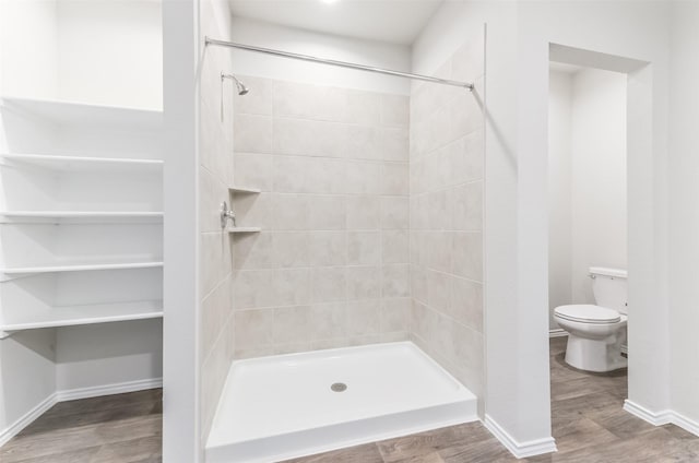 16524 Cascading Pines Ct, Conroe, TX 77302 - bathroom with baseboards, a shower stall, toilet, and wood finished floors