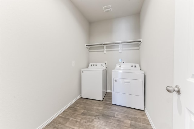 16524 Cascading Pines Ct, Conroe, TX 77302 - laundry area with independent washer and dryer, laundry area, baseboards, and light wood finished floors