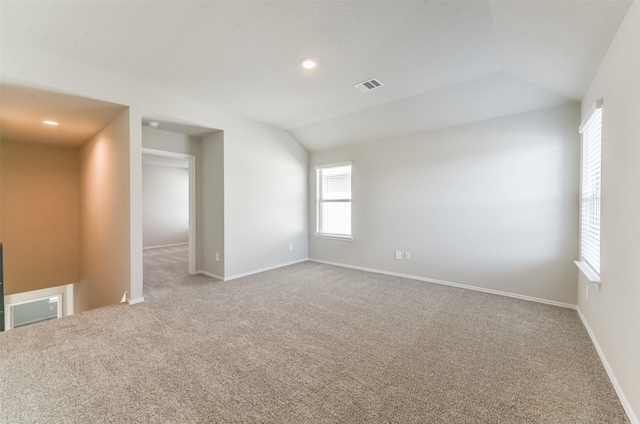 16524 Cascading Pines Ct, Conroe, TX 77302 - empty room featuring carpet flooring, baseboards, visible vents, and lofted ceiling