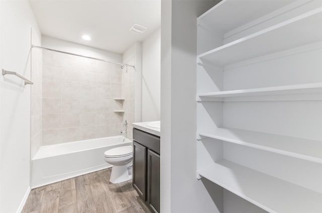 16524 Cascading Pines Ct, Conroe, TX 77302 - full bath with vanity, visible vents, wood finished floors, toilet, and shower / washtub combination