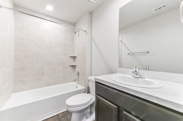 16524 Cascading Pines Ct, Conroe, TX 77302 - full bathroom featuring visible vents, wood finished floors, shower / washtub combination, vanity, and toilet