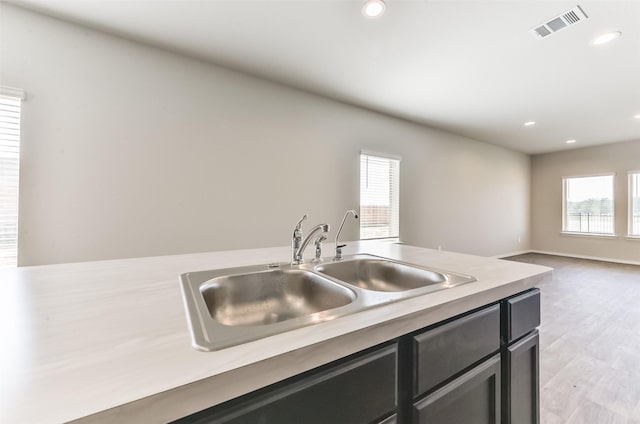 16524 Cascading Pines Ct, Conroe, TX 77302 - kitchen with a sink, light countertops, dark cabinetry, recessed lighting, and visible vents