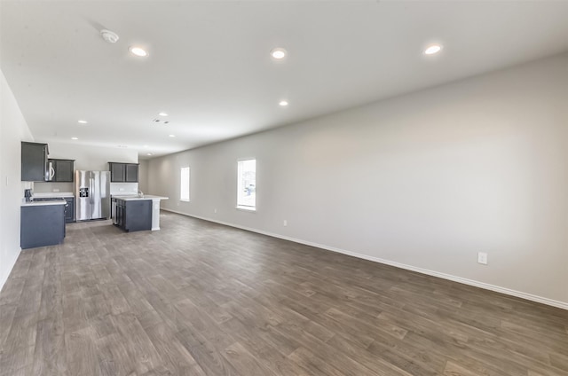 16524 Cascading Pines Ct, Conroe, TX 77302 - unfurnished living room featuring baseboards, recessed lighting, and dark wood-type flooring