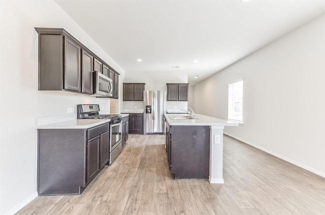 16524 Cascading Pines Ct, Conroe, TX 77302 - kitchen featuring stainless steel appliances, light wood finished floors, and dark brown cabinets