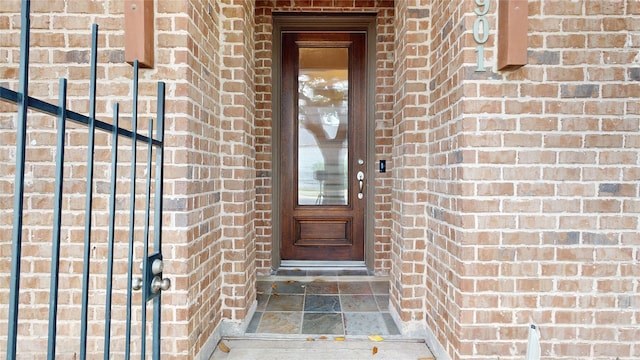 property entrance with brick siding