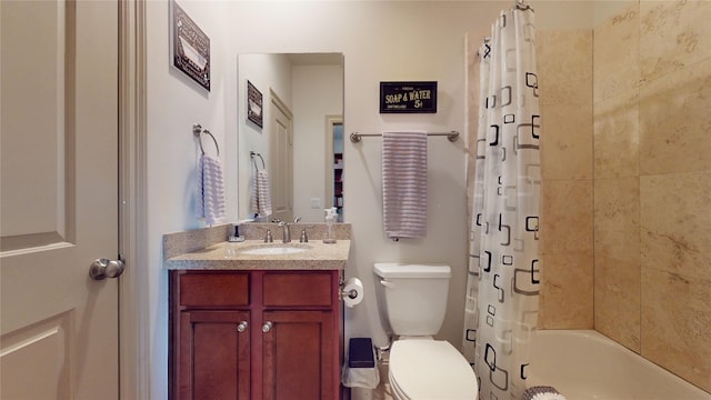 bathroom with vanity, shower / tub combo, and toilet