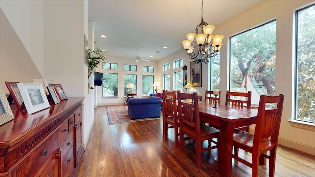 dining area with ceiling fan with notable chandelier, recessed lighting, and wood finished floors