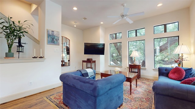 living area with a healthy amount of sunlight, baseboards, recessed lighting, and wood finished floors