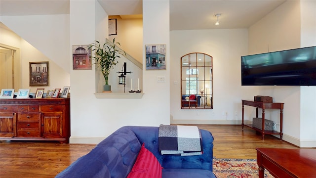 living area featuring baseboards and wood finished floors