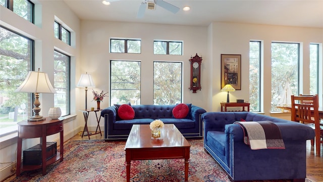 living area with recessed lighting, ceiling fan, and wood finished floors