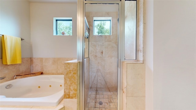 bathroom featuring a whirlpool tub and a stall shower