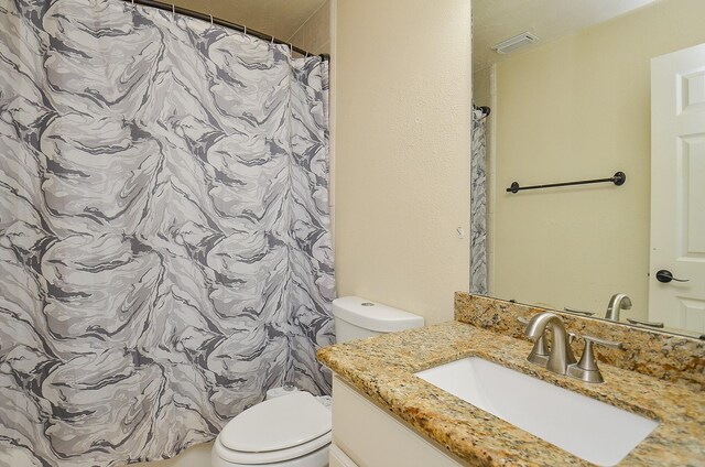 18235 Bonham Oaks Ct, Richmond, TX 77407 - full bathroom with vanity, a shower with curtain, toilet, and visible vents