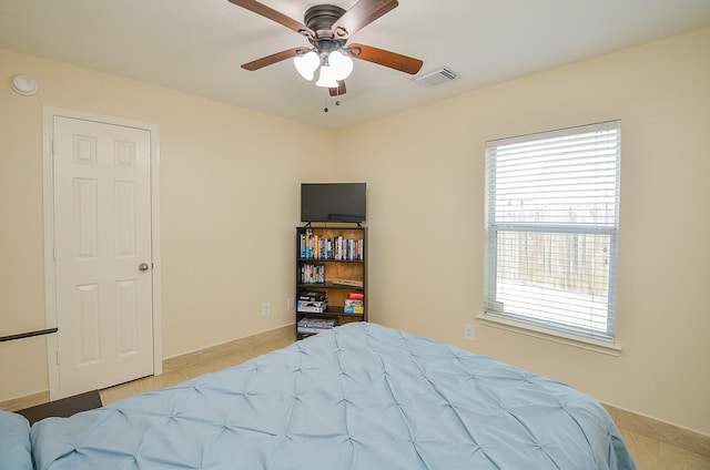 18235 Bonham Oaks Ct, Richmond, TX 77407 - bedroom with visible vents, baseboards, light tile patterned floors, and multiple windows