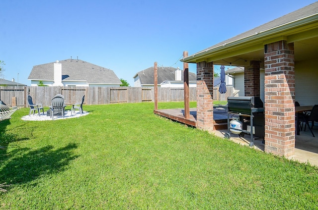 18235 Bonham Oaks Ct, Richmond, TX 77407 - view of yard featuring a fenced backyard, a wooden deck, a fire pit, and a patio area