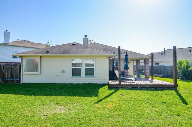 18235 Bonham Oaks Ct, Richmond, TX 77407 - rear view of property with a lawn, a wooden deck, and a fenced backyard