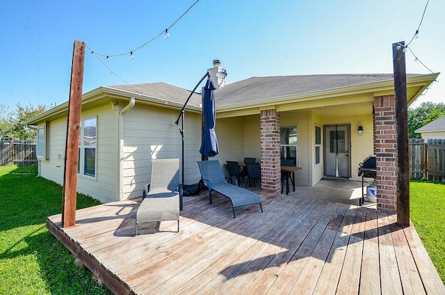 18235 Bonham Oaks Ct, Richmond, TX 77407 - back of house with fence, a chimney, a yard, and a deck