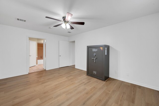 unfurnished bedroom featuring light wood-style floors, baseboards, and visible vents