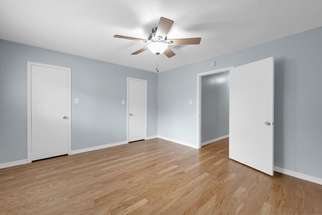 unfurnished room with baseboards, ceiling fan, and light wood-style flooring