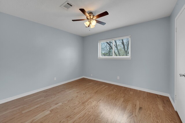 unfurnished room with light wood-type flooring, baseboards, ceiling fan, and visible vents