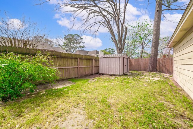 view of yard featuring an outdoor structure, a fenced backyard, and a storage shed