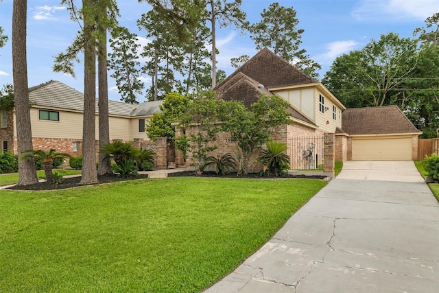 view of front of property with fence, a front yard, driveway, and brick siding