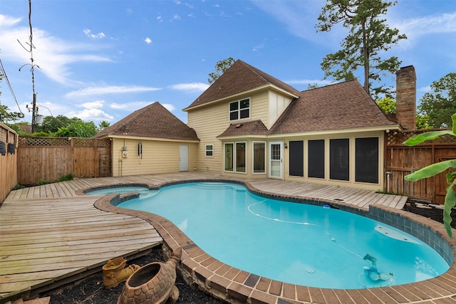 view of swimming pool featuring an in ground hot tub, a fenced in pool, a wooden deck, and a fenced backyard