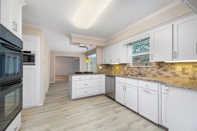 kitchen featuring tasteful backsplash, a sink, black appliances, a peninsula, and ornamental molding