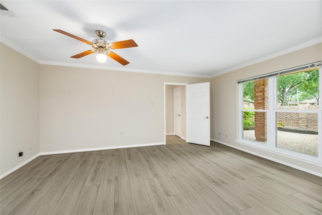 spare room featuring baseboards, ornamental molding, and light wood-type flooring