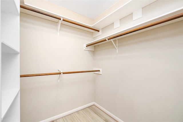 walk in closet featuring light wood-style flooring