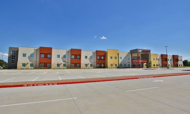 view of building exterior featuring uncovered parking