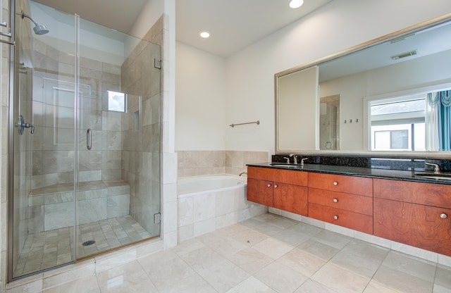 402 Parker St, Houston, TX 77007 - full bath featuring a sink, double vanity, visible vents, a bath, and a stall shower