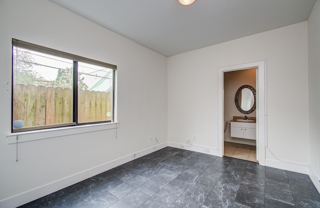 402 Parker St, Houston, TX 77007 - unfurnished room featuring a sink, baseboards, and stone finish floor