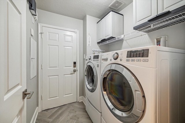 laundry area with independent washer and dryer, baseboards, and cabinet space