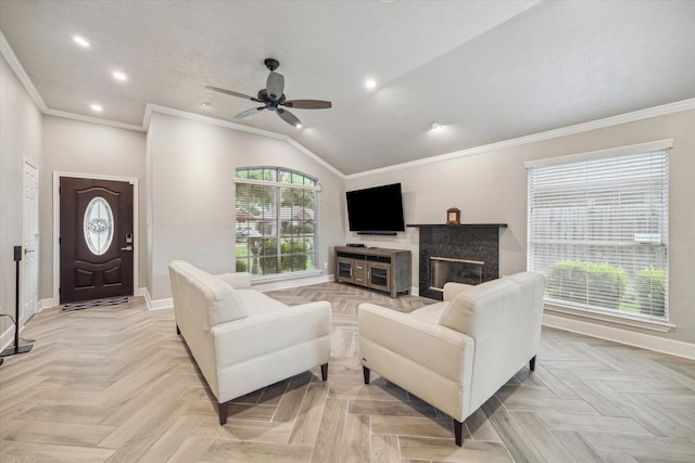 living room featuring baseboards, ornamental molding, ceiling fan, and plenty of natural light