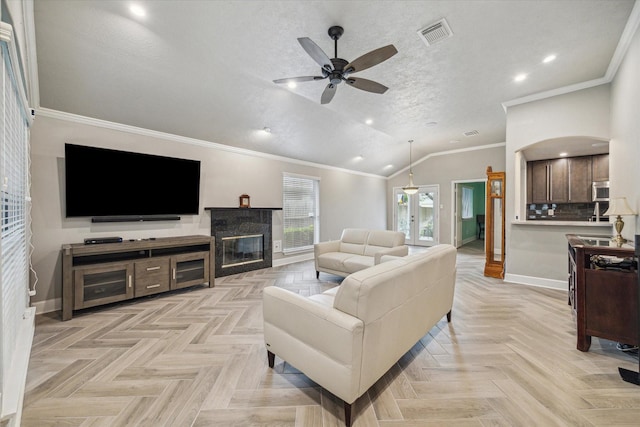 living room featuring a ceiling fan, visible vents, a tile fireplace, baseboards, and recessed lighting
