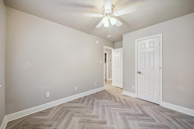 unfurnished bedroom with a ceiling fan and baseboards