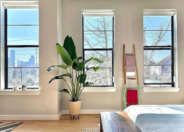 bedroom featuring baseboards and wood finished floors