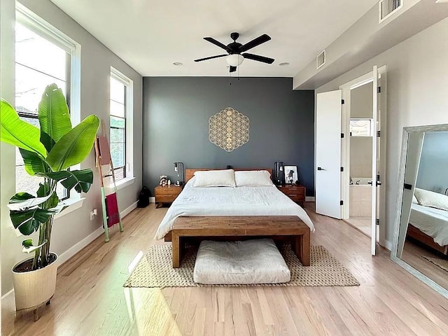 bedroom with visible vents, a ceiling fan, baseboards, and light wood-type flooring