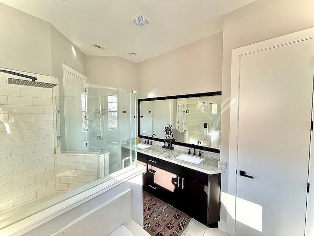 full bath with double vanity, visible vents, a sink, and a stall shower