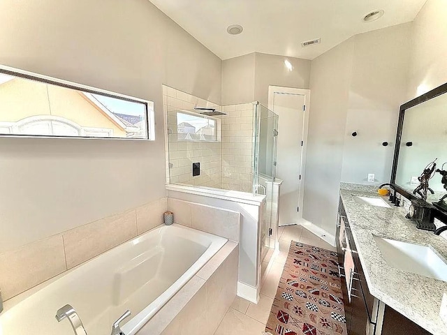 bathroom with tile patterned floors, a sink, a bath, and a stall shower