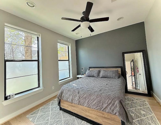 bedroom with baseboards, ceiling fan, recessed lighting, and wood finished floors