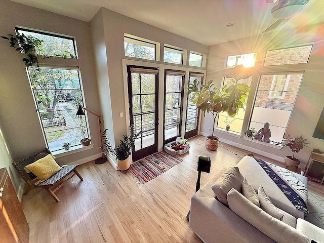 doorway to outside featuring baseboards and light wood-style floors