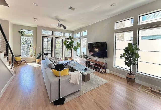 living room with baseboards, a ceiling fan, recessed lighting, and light wood-type flooring