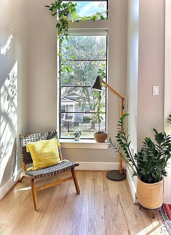 sitting room with baseboards and wood finished floors