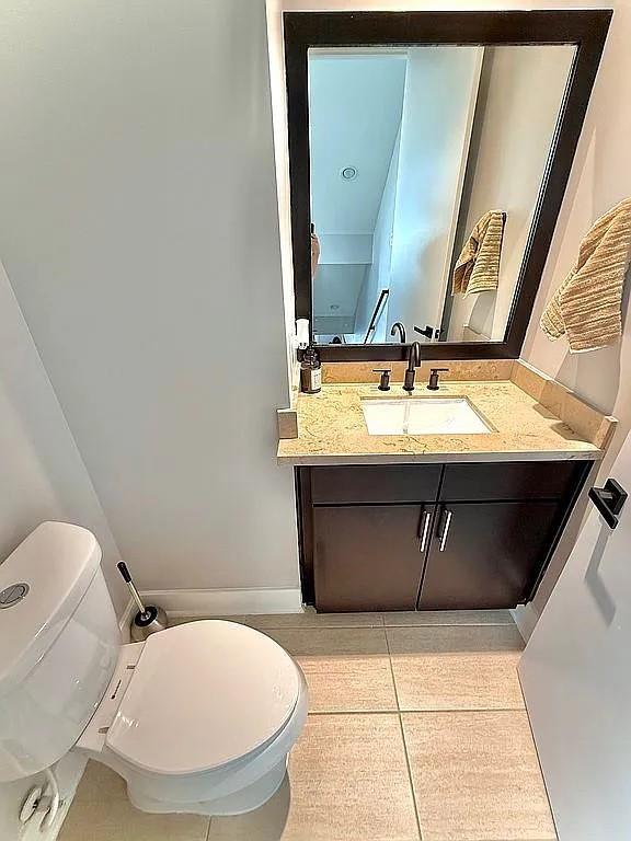 bathroom with vanity, tile patterned floors, and toilet