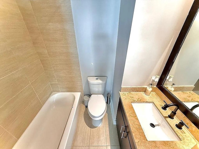 bathroom featuring vanity, tile patterned floors, and toilet